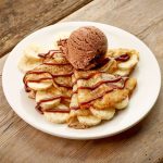 Crepes with banana and chocolate ice cream Crepes with banana and chocolat icecream on wooden table
