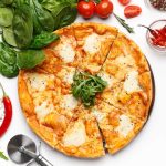 Italian Mozzarella Pizza On White Table, Top View Italian Mozzarella Pizza And Basil Leaves Nearby On White Table, Top View, Crop